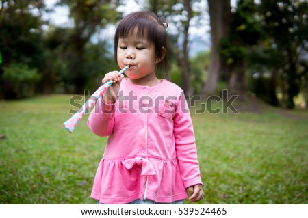 Picture of child development of 2 year and 2 months baby playing  in the garden : For concept such as happy kid, learning, play and exploration.