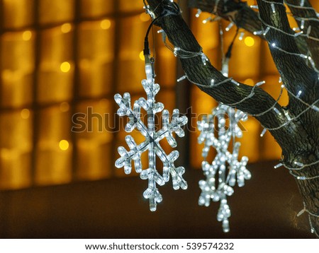 Closeup of Christmas decoration lights on trees .