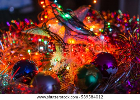 Multi-colored garland from bulbs and a star, Christmas toys