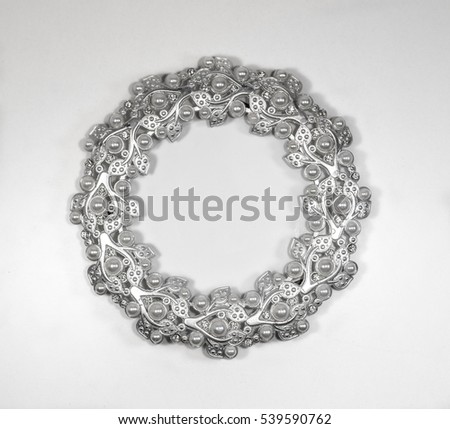 Oval silver photo frame with pearls on white background