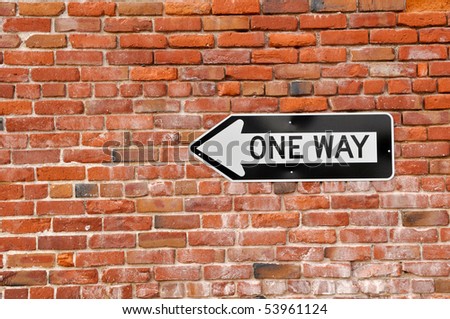 Brick Wall with Black and White One Way Sign