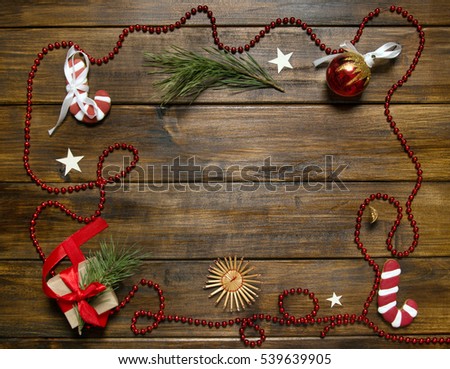 Sugar cane and snow flake on wooden background with presents.