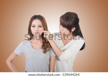 Asian woman with her friend, studio shot portrait.