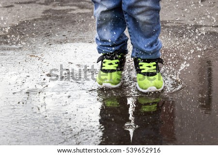baby foot jump in a puddle