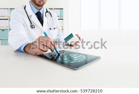 doctor uses the tablet with icons, in office desk 