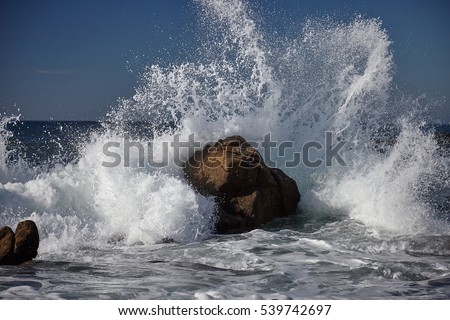 splits waves against rocks in the sea Royalty-Free Stock Photo #539742697