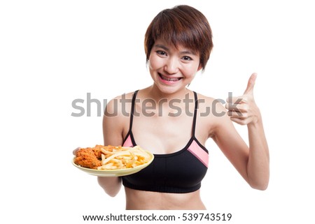 Asian healthy girl eat  french fries and  fired chicken  show thumbs up  isolated on white background.