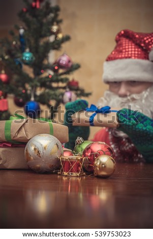 Christmas holiday background of wooden table against decorated Christmas tree and fireplace
