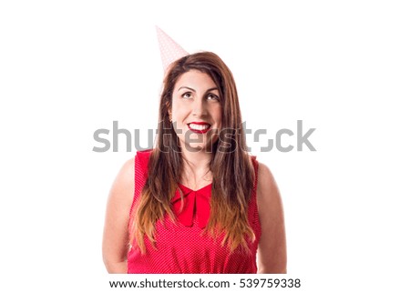 
A happy young woman with a birthday hat isolated on white background