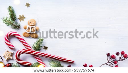 Christmas holiday sweets and fir tree branch on white background. Christmas gift composition.  Flat lay, top view.
