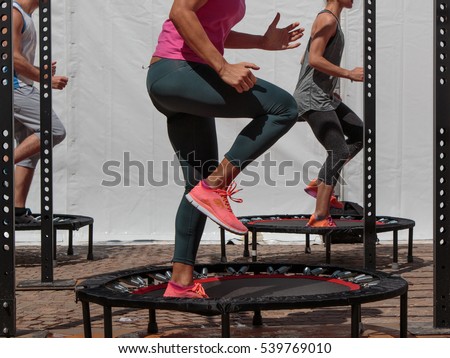 Mini Trampoline Workout: Girl doing Fitness Exercise in Class at Gym Royalty-Free Stock Photo #539769010