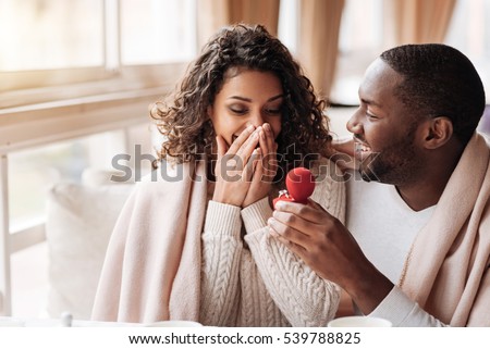 Amazed African American couple getting engaged in the cafe Royalty-Free Stock Photo #539788825