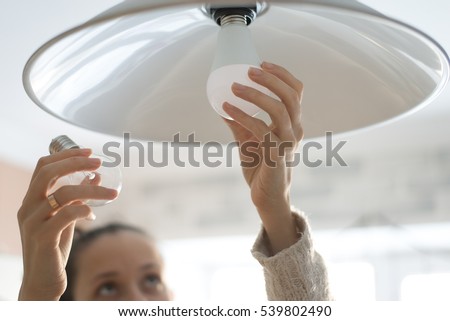 Power save LED lamp changing Royalty-Free Stock Photo #539802490