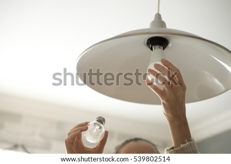 Power save LED lamp changing Royalty-Free Stock Photo #539802514