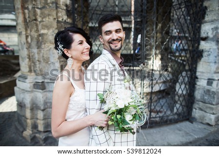 wedding couple outdoor with bouquet of flowers