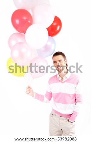 Image of attractive man holding colorful balloons and looking at camera