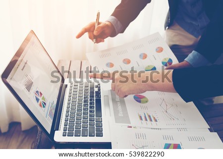 Team of business investment consultant analyzing company annual financial report balance sheet statement working with documents graphs. Concept picture of economy, market, office, money and tax. Royalty-Free Stock Photo #539822290