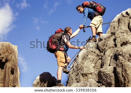 Help, support and help in a dangerous situation to hike in the mountains. Royalty-Free Stock Photo #539838106