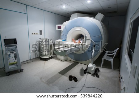 Patient being scanned and diagnosed on a MRI (magnetic resonance imaging) scanner in a hospital. Modern medical equipment, medicine and health care concept.   Royalty-Free Stock Photo #539844220