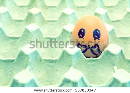 Brown chicken egg with gloves arranged in carton