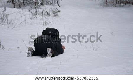 the photographer lies on the snow takes nature landscape winter snow forest