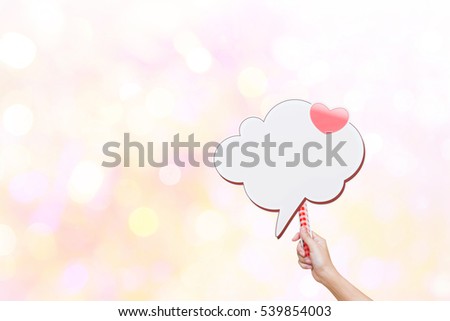 woman holding pink sign board like a cloud and pink heart  in her hands on vivid bokeh background,with copy space,Concept festivals,valentine,newyear,chirismas