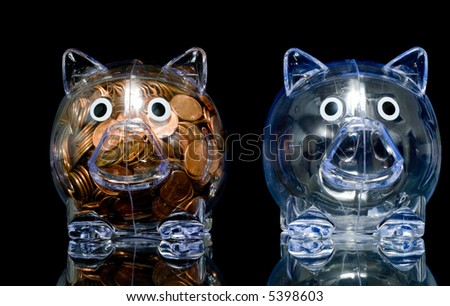 Two clear acrylic piggy banks one stuffed full of american pennies the other empty, Illustration of the "haves" and the "have nots"