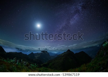 night sky stars with milky way long exposure on mountain background on dark blue sky