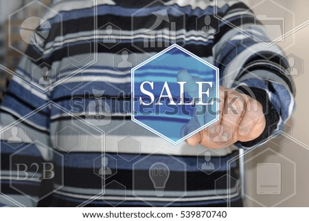 A businessman pushes a button SALE on the touch screen the web . The concept of online auctions, shopping, real estate.
