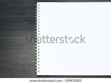 Blank sketchbook with white pages  isolated on black background.