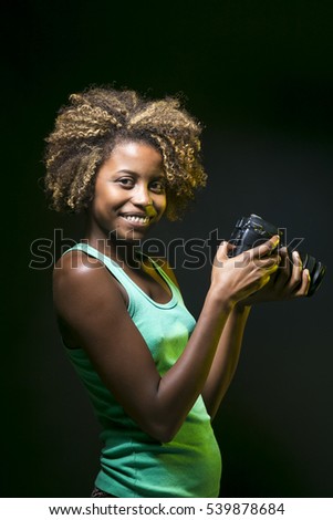 Young black girl with digital camera