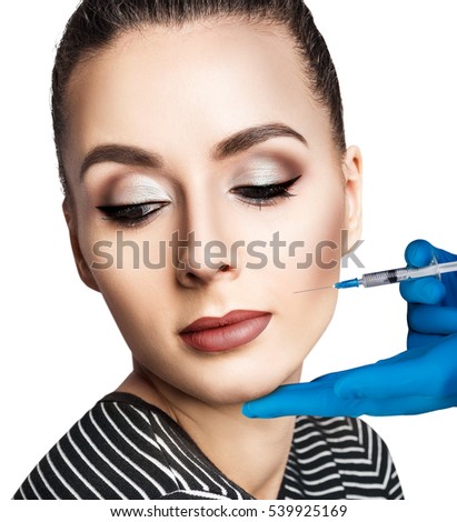 Woman make an injection from a syringe.