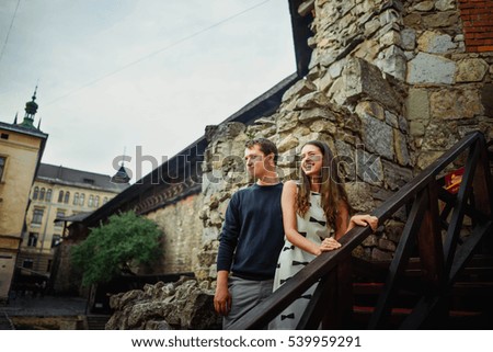 beautiful and happy woman and man standing on the stairs