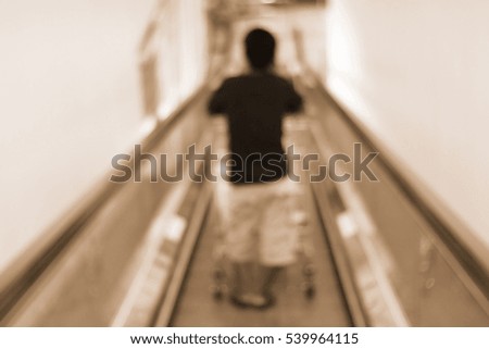 Blurred abstract background and can be illustration to article of people on escalator