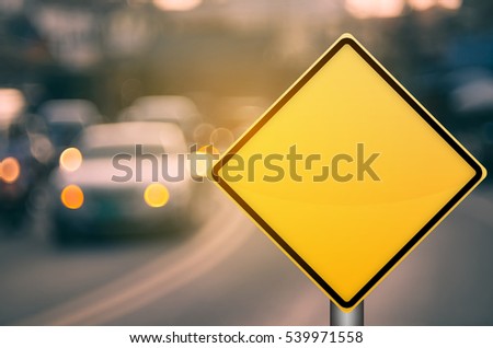 Empty yellow traffic sign on blur traffic road with colorful bokeh light abstract background. Copy space of transportation and travel concept. Retro tone filter effect color style. Royalty-Free Stock Photo #539971558