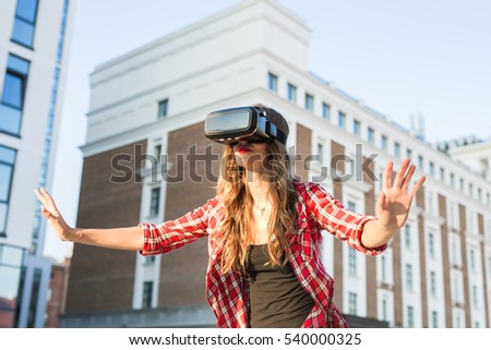 Woman with virtual reality goggles in the city