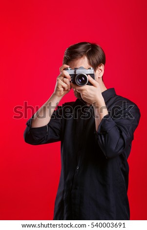 Man holding vintage camera. Photographer takes a photo on a film camera. Man is unrecognizable.