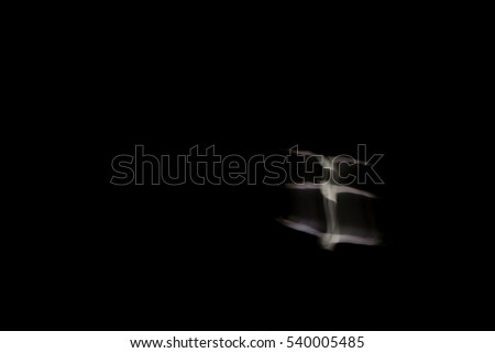 Abstract bird. Flying bird. No effect. Slow shutter speed photography. Black sky background.