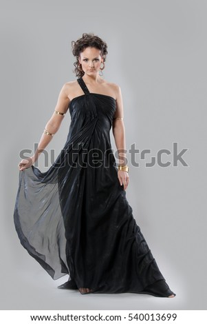 picture of beautiful woman in a dress of ancient Greece on a gray background