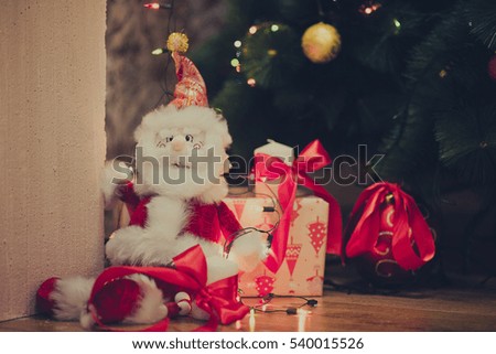 Background for new year: Santa Claus by the Christmas tree
