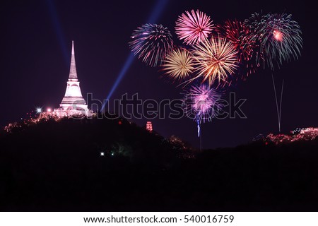 Annual firework festival over pagoda on the mountain. 
Firework sparkling in dark sky celebrating for religious temples on the top of the hills, celebration background