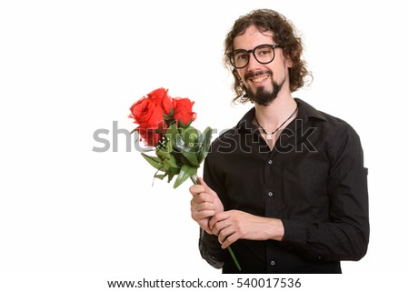 Happy handsome Caucasian man holding red roses ready for Valentine's day