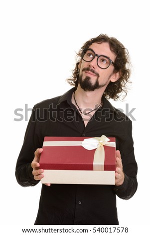 Handsome Caucasian man thinking while holding git box ready for Valentine's day