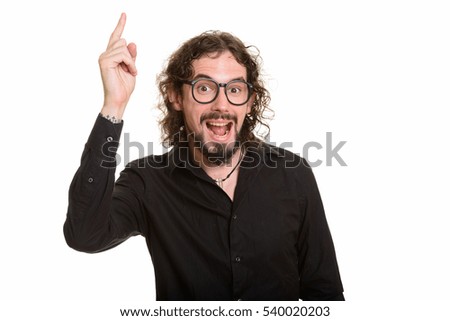 Happy handsome Caucasian man pointing finger up