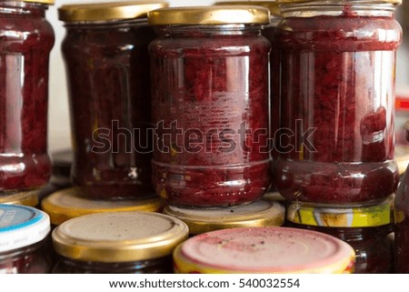 Preserves in jars in home basement. Close up of stocks kept for the winter.