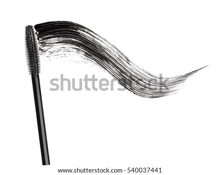 Stroke of black mascara with applicator brush close-up, isolated on white background Royalty-Free Stock Photo #540037441