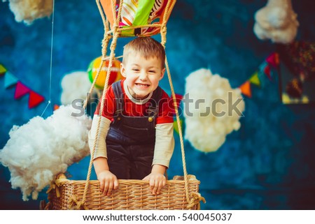 Portrait of a naughty boy in the colorful balloon
