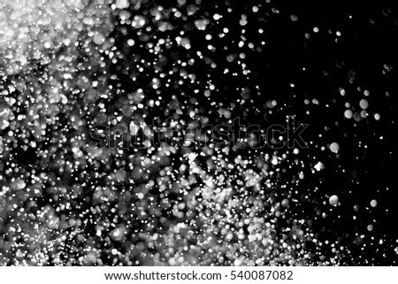 Snowfall isolated on black background. round bokeh or snowflakes particles . Design element