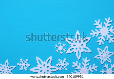 Snowflakes and stars on a blue wooden background