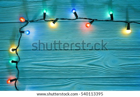 christmas garland lights on wooden rustic background              